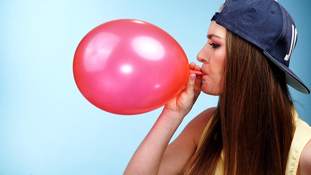 Girl Blowing Balloons