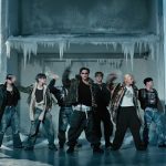 Delapan member ATEEZ menari di depan bangunan beku dalam MV Drip